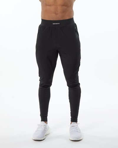 Alphalete Woven 4-Way Stretch 29" Pant Blackout | TVBAUW438
