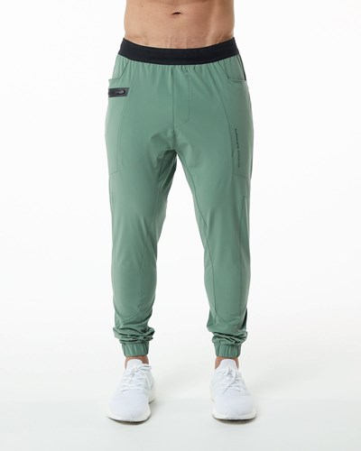 Alphalete Woven 4-Way Stretch 29" Pant Verde | JNAWST614